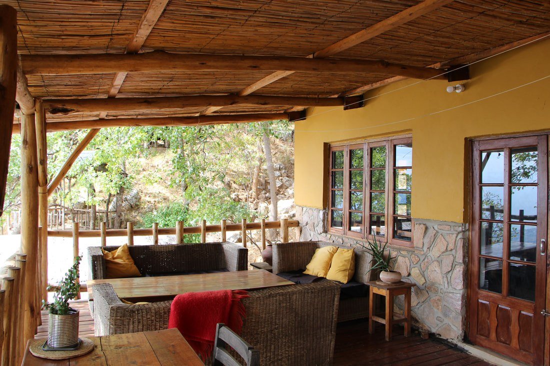 Yellow cushions brighten a thatched-roof lounge deck at The Mushroom Farm